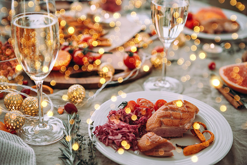 Roasted duck or turkey. Party table with glasses of champagne. Friends celebrating Christmas or New Year eve.